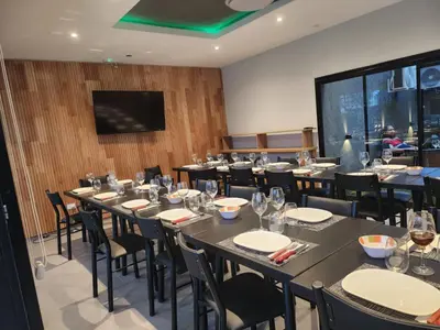 a conference room with tables and chairs and a screen at Hotel El Paraiso Boutique in Villa Carlos Paz