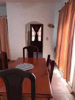 a dining room with a wooden table and chairs at La cantata in Merlo