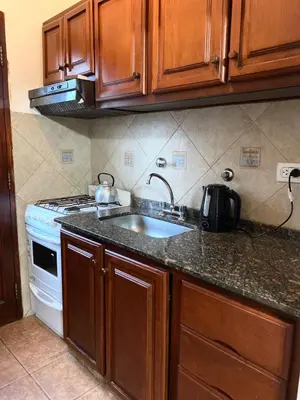 a kitchen with a sink and a stove at La cantata in Merlo