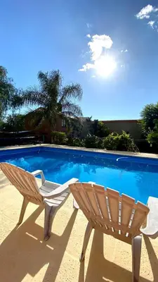 a chair sitting next to a swimming pool at La cantata in Merlo