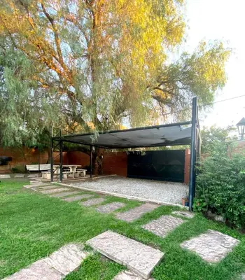 a picnic shelter with a black canopy in a park at La cantata in Merlo