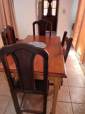 a dining room table with chairs and a wooden table at La cantata in Merlo