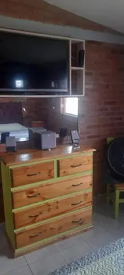 a dresser with a television on top of it at Las Lomitas in Villa Cura Brochero