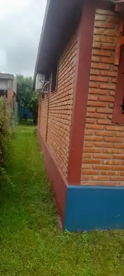 a side of a building with a brick wall at Las Lomitas in Villa Cura Brochero