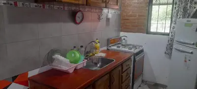 a kitchen with a sink and a stove at Las Lomitas in Villa Cura Brochero