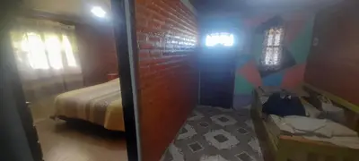 a bedroom with a bed and a brick wall at Las Lomitas in Villa Cura Brochero