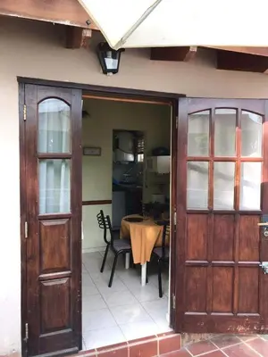 an open door to a patio with a table at Alquiler Temporario a una cuadra del reloj cucu in Villa Carlos Paz