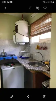 a kitchen with a sink and a microwave at Alquiler Temporario a una cuadra del reloj cucu in Villa Carlos Paz