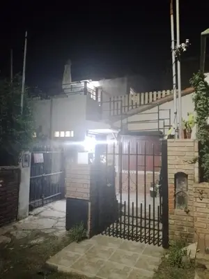 a gate in front of a house at night at Alquiler Temporario a una cuadra del reloj cucu in Villa Carlos Paz