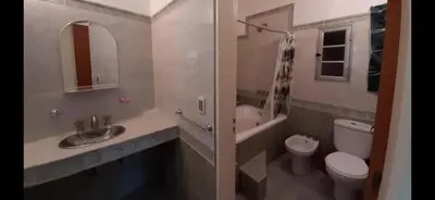 a bathroom with a sink and a toilet and a mirror at Casa para 9 personas en Villa Carlos Paz in Villa Carlos Paz