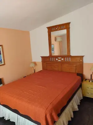 a bedroom with a bed with a mirror on it at Tiempo Libre in Villa Icho Cruz