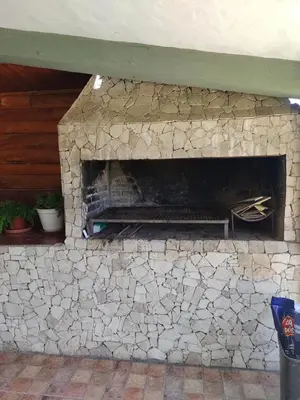 a stone brick fireplace with a stone at Tiempo Libre in Villa Icho Cruz