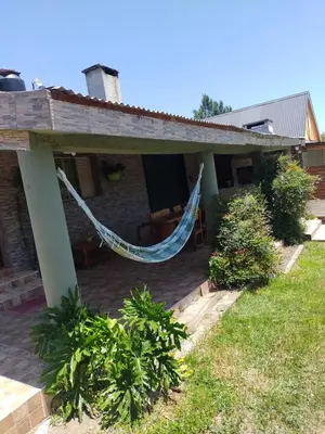 a house with a hammock on a patio at Tiempo Libre in Villa Icho Cruz