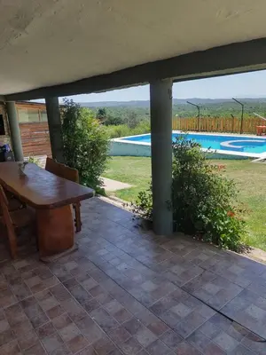 a patio with a table and a swimming pool at Tiempo Libre in Villa Icho Cruz