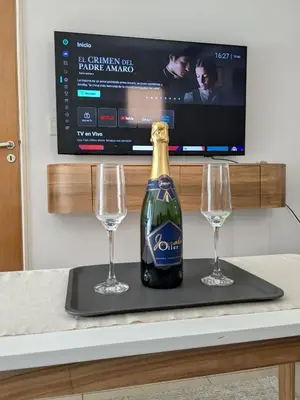 a bottle of champagne and two glasses on a tray at Nórdico Nueva Córdoba in Cordoba