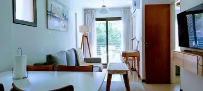 a living room with a table and a couch and a tv at Nórdico Nueva Córdoba in Cordoba