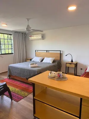 a bedroom with a bed and a table in front of it at Punta Molinos in La Estancia