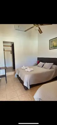 a bedroom with a bed with towels on it at Hosteria Torol Calta in Villa Cura Brochero