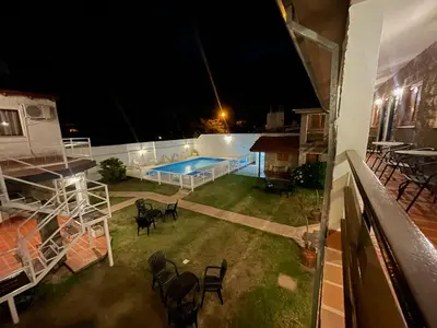 a view of a swimming pool at night at Hosteria Torol Calta in Villa Cura Brochero