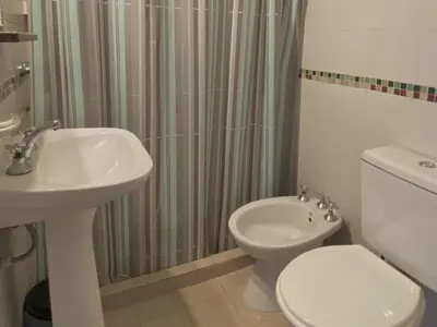 a bathroom with a sink and a toilet and a shower at Hosteria Torol Calta in Villa Cura Brochero
