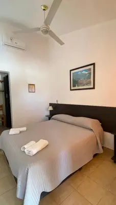 a bedroom with a bed with two towels on it at Hosteria Torol Calta in Villa Cura Brochero