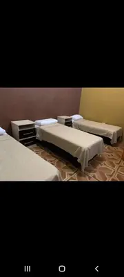 a room with three beds in a room at Casa D&M in Mina Clavero