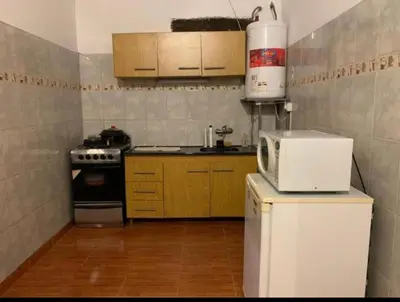 a small kitchen with a refrigerator and a microwave at Casa D&M in Mina Clavero