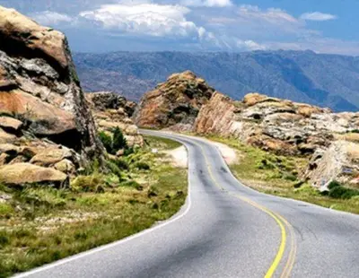 a winding road in the mountains with rocks at Casa D&M in Mina Clavero