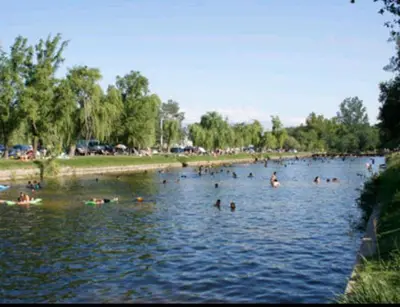 a group of people swimming in a lake at Casa D&M in Mina Clavero