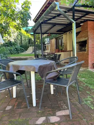 a table and chairs with a blanket on top of it at Departamento Vivaldi in Villa Carlos Paz