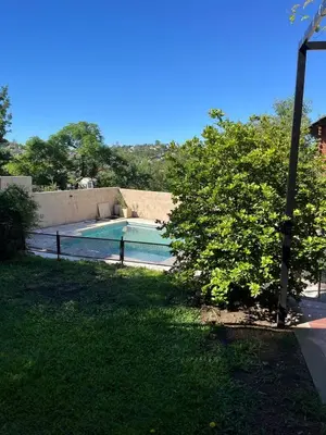 a swimming pool in the yard of a house at Departamento Vivaldi in Villa Carlos Paz