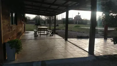 a patio with a table and a picnic table at Naturaleza Serrana in La Estancia