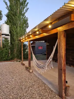 a patio with a hammock under a pergola at Naturaleza Serrana in La Estancia