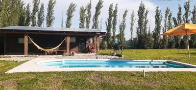 a small swimming pool in a yard with a tent at Naturaleza Serrana in La Estancia