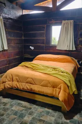 a large bed in a room with a window at Naturaleza Serrana in La Estancia