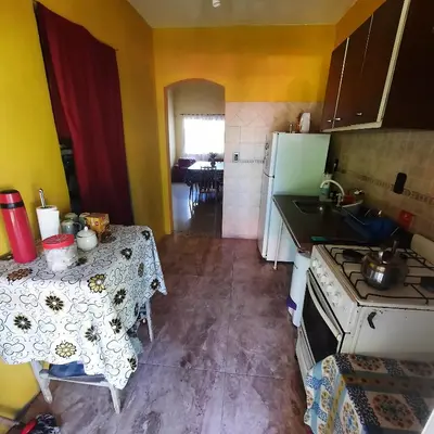 a small kitchen with a table and a stove at La Jose in Santa María