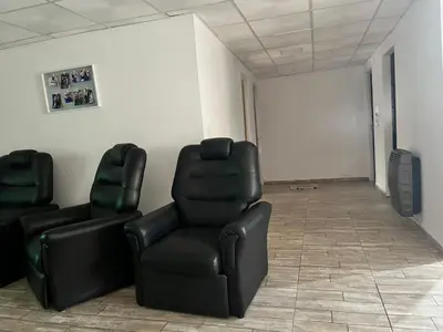 two black chairs sitting in a room with a wall at Adonay VGB in Villa General Belgrano