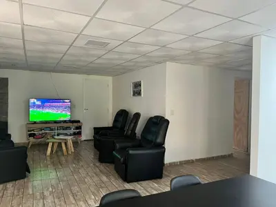 a living room with chairs and a flat screen tv at Adonay VGB in Villa General Belgrano