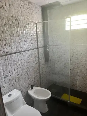 a bathroom with a toilet and a glass shower at Adonay VGB in Villa General Belgrano