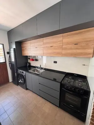 a kitchen with a stove and a sink at Duplex con patio y asador buena ubicacion in Villa Carlos Paz