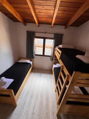 a room with two bunk beds and a window at Duplex con patio y asador buena ubicacion in Villa Carlos Paz