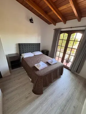 a bedroom with a bed with two towels on it at Duplex con patio y asador buena ubicacion in Villa Carlos Paz
