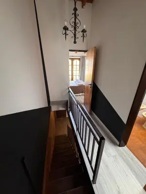 a staircase in a house with a chandelier at Duplex con patio y asador buena ubicacion in Villa Carlos Paz