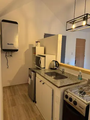 a small kitchen with a sink and a microwave at Depto 24 en Barrio Villa Belgrano excelente ubicación in Cordoba