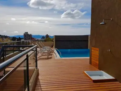 a deck with a swimming pool on top of a building at depto en edificio miralejos 8 in Cordoba