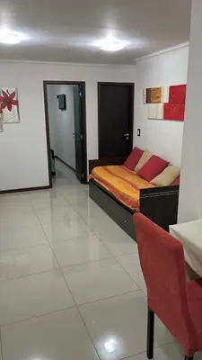 a bedroom with a bed and a chair in it at depto en edificio miralejos 8 in Cordoba
