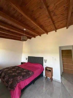 a bedroom with a bed and a wooden ceiling at Valle Serrano in Mina Clavero