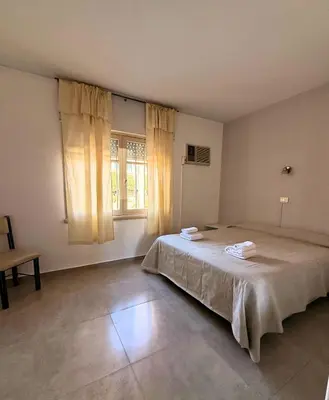 a bedroom with a large bed and a window at Hotel Montecarlo PSH in Villa Carlos Paz