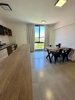 a large room with a table and a large window at Depa a Estrenar en el Centro, Pile, Aire Ac in Villa Carlos Paz