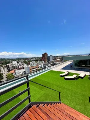 a view from the balcony of a building with a green lawn at Depa a Estrenar en el Centro, Pile, Aire Ac in Villa Carlos Paz